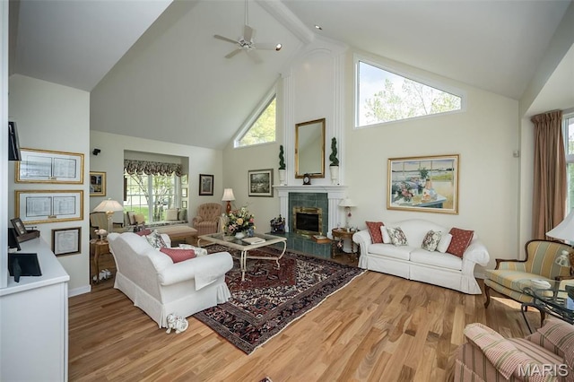 1417 Wheatfield Ln, Saint Albans, MO 63073 - living area featuring high vaulted ceiling, a tiled fireplace, light wood-style floors, and ceiling fan