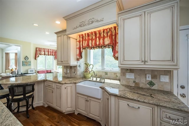 1417 Wheatfield Ln, Saint Albans, MO 63073 - kitchen featuring a peninsula, tasteful backsplash, dark wood-style floors, light stone countertops, and recessed lighting