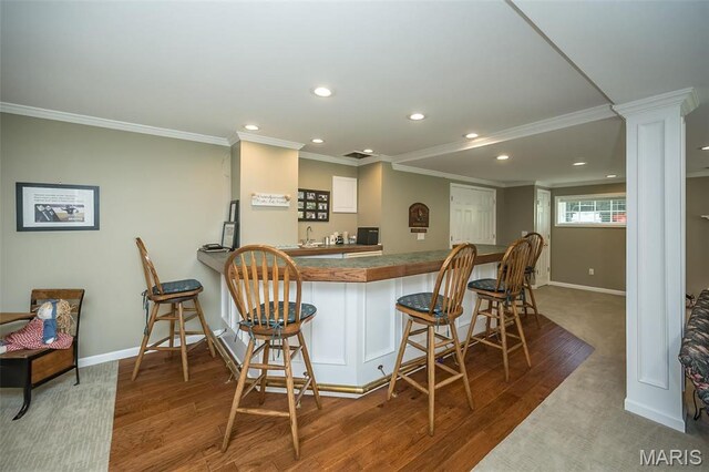 1417 Wheatfield Ln, Saint Albans, MO 63073 - kitchen featuring crown molding, recessed lighting, a breakfast bar area, white cabinetry, and wood finished floors