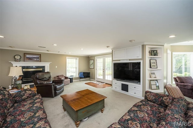1417 Wheatfield Ln, Saint Albans, MO 63073 - living area featuring crown molding, light colored carpet, plenty of natural light, french doors, and a premium fireplace