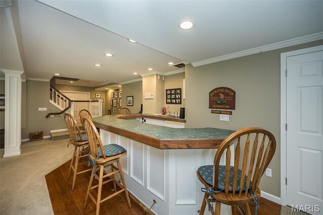 1417 Wheatfield Ln, Saint Albans, MO 63073 - indoor wet bar with ornamental molding, recessed lighting, ornate columns, and dark carpet