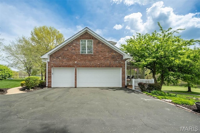 1417 Wheatfield Ln, Saint Albans, MO 63073 - view of side of home featuring brick siding and a garage