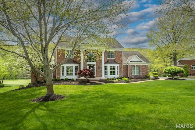 1417 Wheatfield Ln, Saint Albans, MO 63073 - greek revival inspired property with a front yard and brick siding