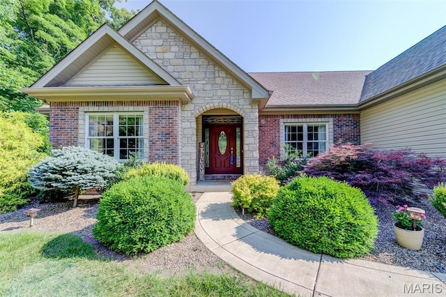 4485 Killdeer Dr, Augusta, MO 63332 - view of exterior entry featuring brick siding, stone siding, and a shingled roof