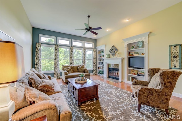 4485 Killdeer Dr, Augusta, MO 63332 - living area with a ceiling fan, a fireplace, wood finished floors, recessed lighting, and built in shelves