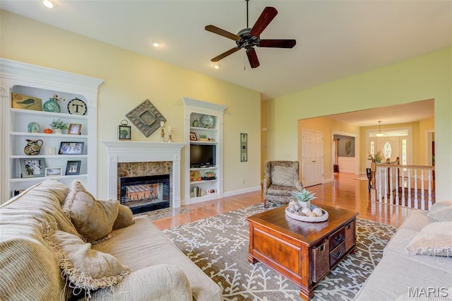 4485 Killdeer Dr, Augusta, MO 63332 - living room with wood finished floors, ceiling fan, a fireplace, built in shelves, and recessed lighting
