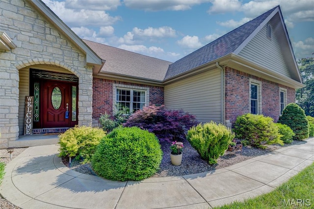 4485 Killdeer Dr, Augusta, MO 63332 - property entrance featuring a shingled roof, brick siding, and stone siding