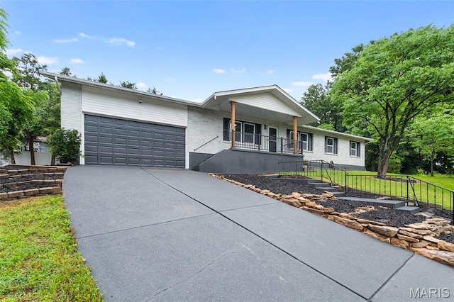 2019 San Pedro Dr, Arnold, MO 63010 - ranch-style house featuring concrete driveway, covered porch, a garage, and a front lawn