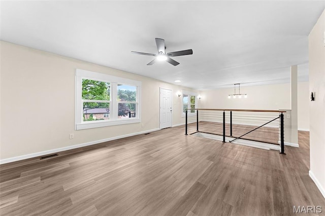 2019 San Pedro Dr, Arnold, MO 63010 - empty room featuring a ceiling fan, wood finished floors, and a chandelier