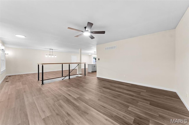 2019 San Pedro Dr, Arnold, MO 63010 - unfurnished room with a ceiling fan, wood finished floors, and a chandelier