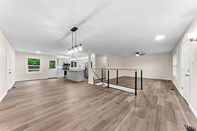2019 San Pedro Dr, Arnold, MO 63010 - unfurnished living room featuring light wood-style flooring, healthy amount of natural light, recessed lighting, and ceiling fan