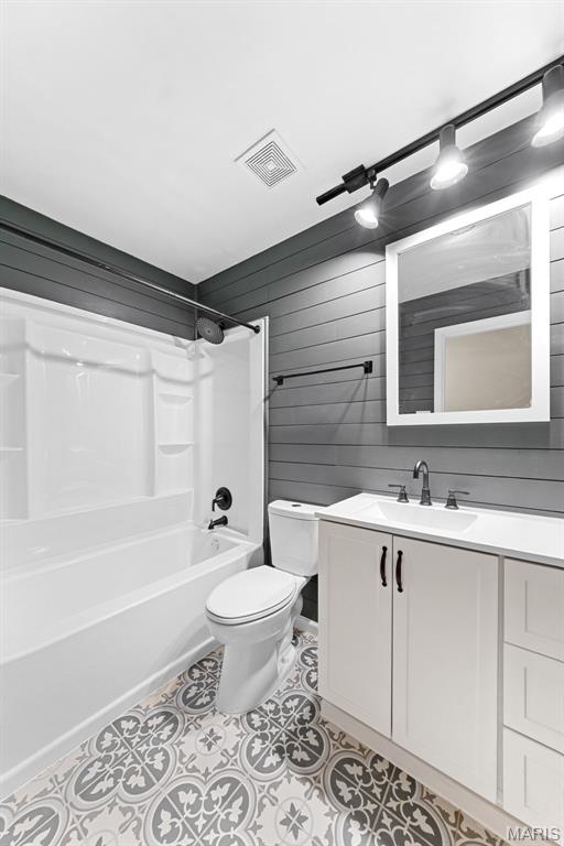 2019 San Pedro Dr, Arnold, MO 63010 - full bath with vanity, shower / tub combination, tile patterned floors, and wood walls
