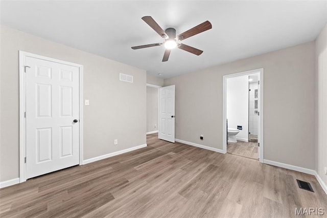 2019 San Pedro Dr, Arnold, MO 63010 - unfurnished bedroom featuring light wood-style flooring, connected bathroom, and ceiling fan