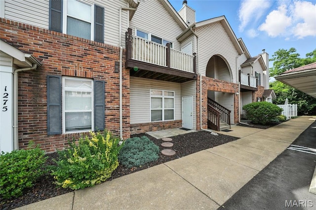 1275 Gardens Circle Drive E, Saint Louis, MO 63125 - property entrance featuring a balcony and brick siding