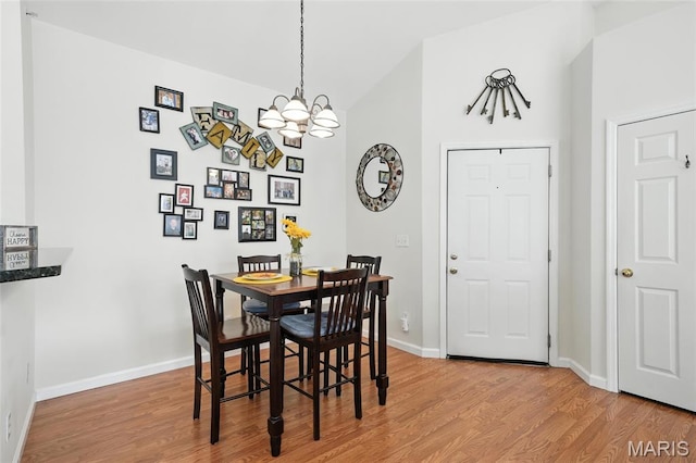 1275 Gardens Circle Drive E, Saint Louis, MO 63125 - dining room with light wood-style floors, a chandelier, and vaulted ceiling