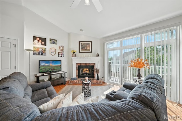 1275 Gardens Circle Drive E, Saint Louis, MO 63125 - living area featuring a ceiling fan, wood finished floors, vaulted ceiling, and a brick fireplace