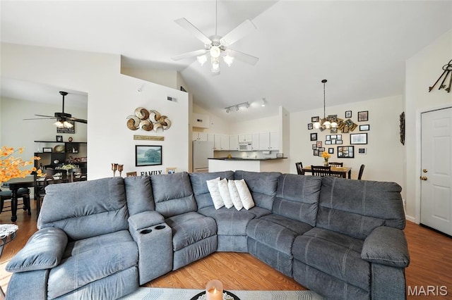 1275 Gardens Circle Drive E, Saint Louis, MO 63125 - living area with a ceiling fan, lofted ceiling, light wood finished floors, and a chandelier