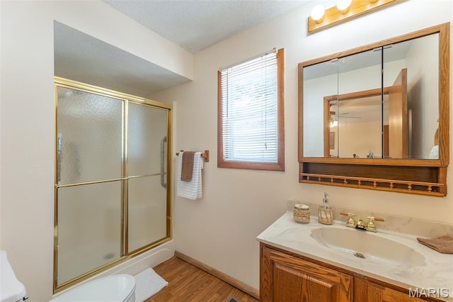39 Rock Ridge Rd, Wappapello, MO 63966 - bathroom featuring a shower with door, wood finished floors, vanity, and ceiling fan