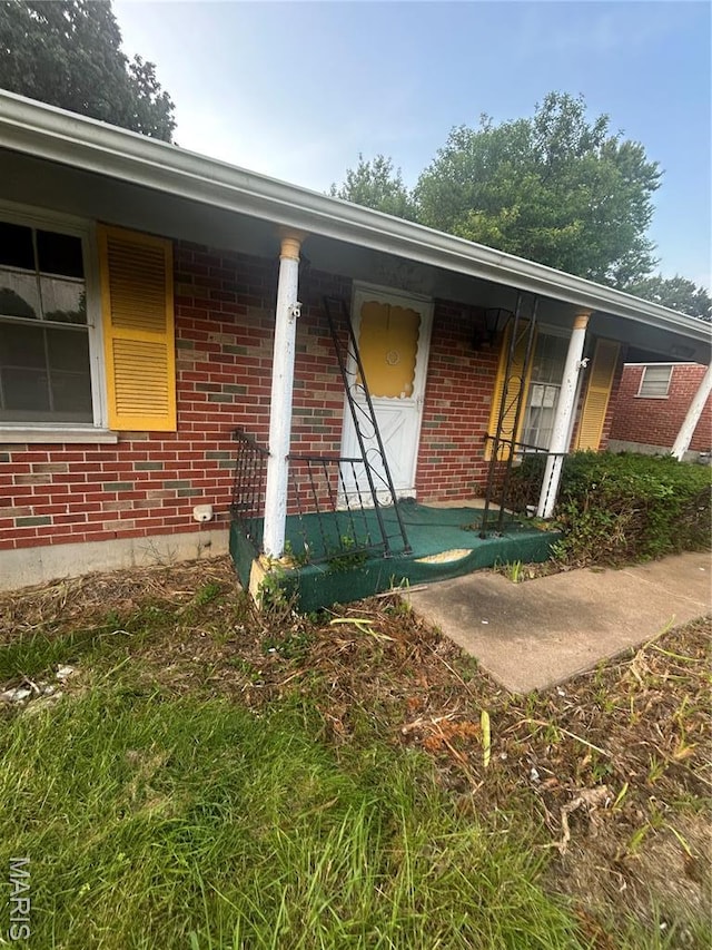7250 Howdershell Rd, Hazelwood, MO 63042 - entrance to property with a porch and brick siding