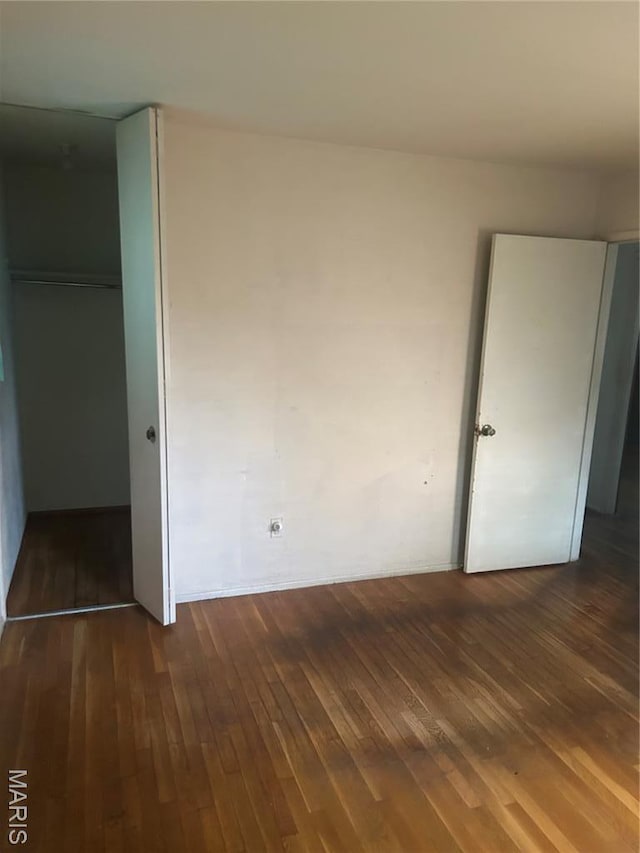 7250 Howdershell Rd, Hazelwood, MO 63042 - unfurnished bedroom with dark wood-style flooring and a closet