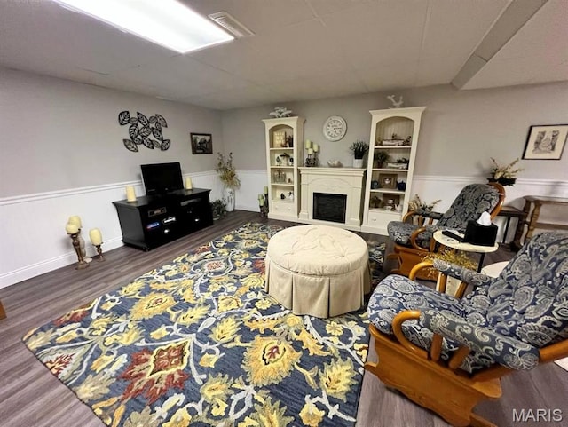 2302 Stonebrook, Dexter, MO 63841 - living area featuring wood finished floors, a fireplace, and a wainscoted wall