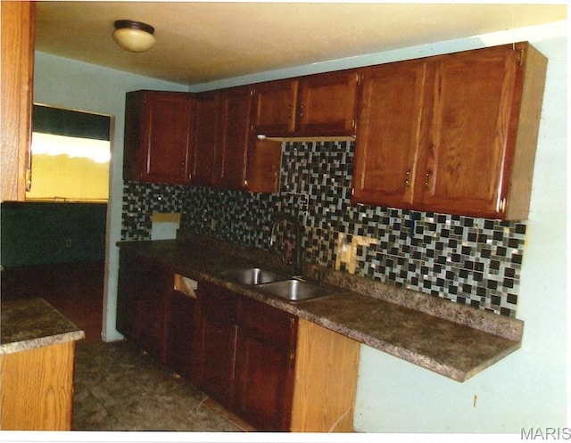 33 Potomac Dr, Fairview Heights, IL 62208 - kitchen with a sink, backsplash, and dark countertops