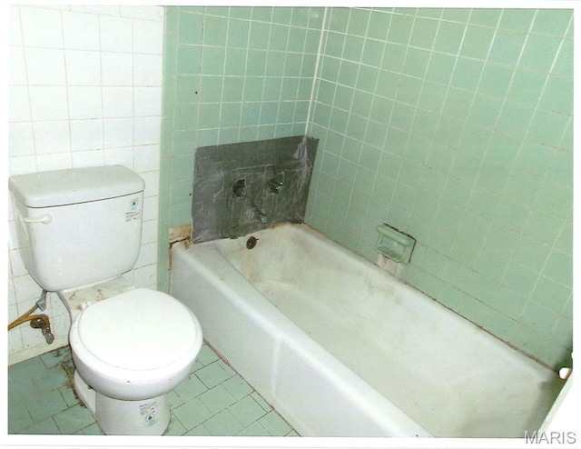 33 Potomac Dr, Fairview Heights, IL 62208 - full bathroom with a bathtub, tile patterned floors, tile walls, and toilet