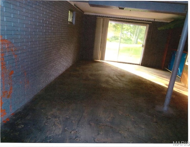 33 Potomac Dr, Fairview Heights, IL 62208 - empty room featuring brick wall and wood finished floors