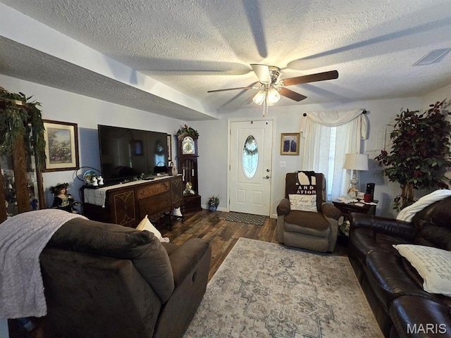 730 N Walnut St, Dexter, MO 63841 - living area featuring a textured ceiling, a ceiling fan, and wood finished floors