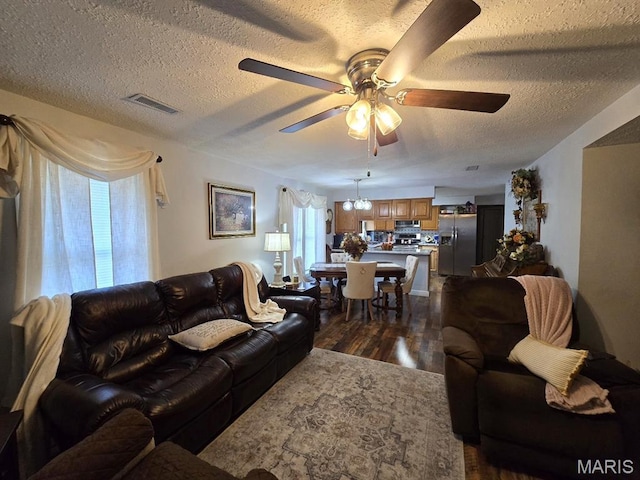 730 N Walnut St, Dexter, MO 63841 - living room featuring ceiling fan, a textured ceiling, dark wood-style floors, and healthy amount of natural light