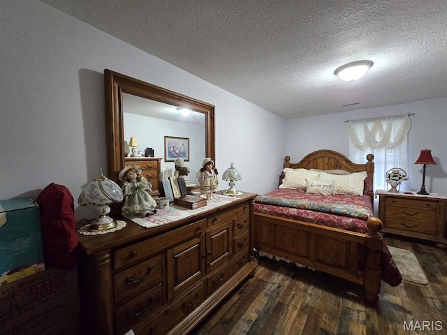 730 N Walnut St, Dexter, MO 63841 - bedroom featuring dark wood-style flooring and a textured ceiling