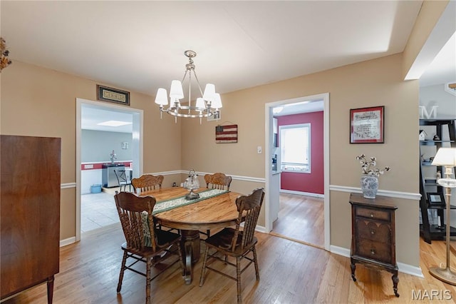 923 N Geyer Rd, Kirkwood, MO 63122 - dining room featuring wood finished floors and a chandelier