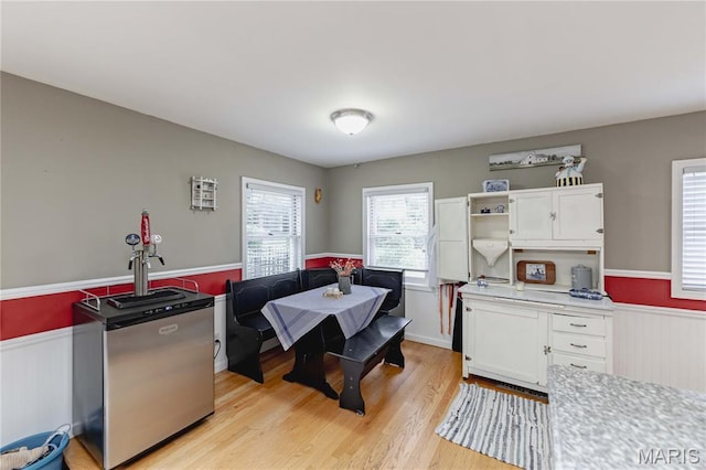 923 N Geyer Rd, Kirkwood, MO 63122 - dining area featuring a wainscoted wall and light wood-style floors
