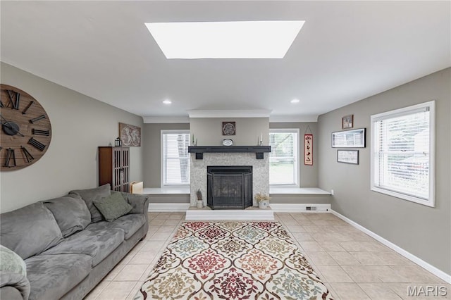923 N Geyer Rd, Kirkwood, MO 63122 - living room featuring light tile patterned floors, a fireplace with raised hearth, healthy amount of natural light, and recessed lighting