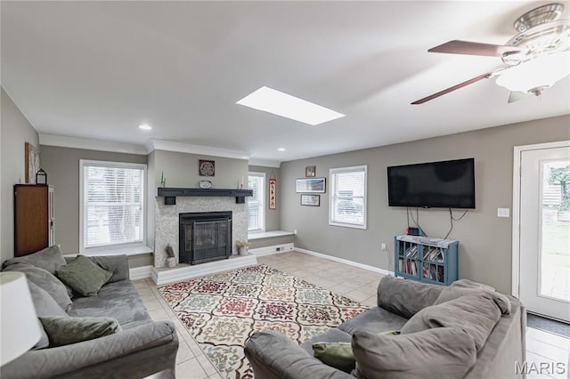 923 N Geyer Rd, Kirkwood, MO 63122 - living area featuring plenty of natural light, a glass covered fireplace, light tile patterned flooring, ceiling fan, and recessed lighting