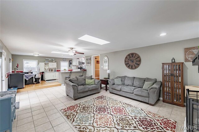 923 N Geyer Rd, Kirkwood, MO 63122 - living area featuring light tile patterned floors, a skylight, and a ceiling fan