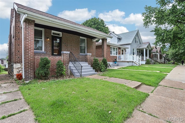 5532 Lansdowne Ave, Saint Louis, MO 63109 - view of front facade featuring brick siding, covered porch, and a front lawn