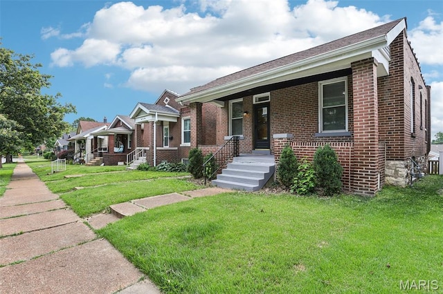 5532 Lansdowne Ave, Saint Louis, MO 63109 - bungalow-style house featuring brick siding, a front yard, and a porch