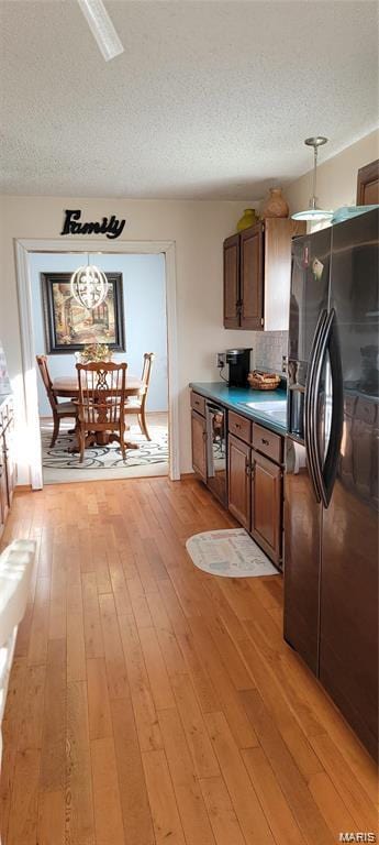 405 E Bittersweet Dr, Gerald, MO 63037 - kitchen with freestanding refrigerator, beverage cooler, a textured ceiling, light wood-style flooring, and brown cabinets