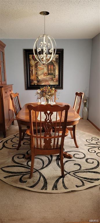 405 E Bittersweet Dr, Gerald, MO 63037 - dining space featuring a chandelier and a textured ceiling