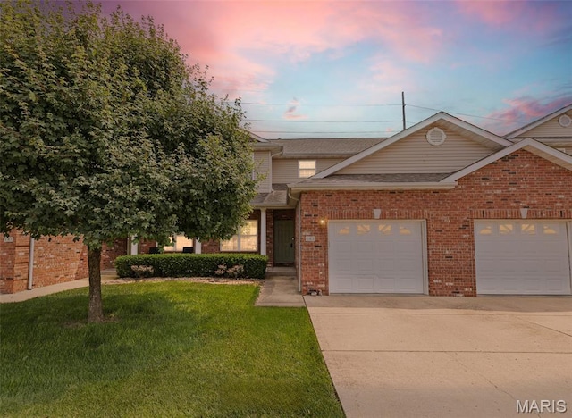 643 Titan Dr, Ofallon, IL 62269 - view of front of house featuring concrete driveway, brick siding, a front lawn, a garage, and roof with shingles