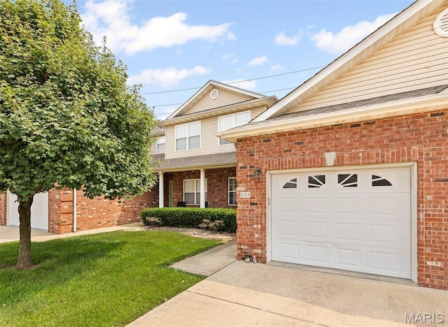643 Titan Dr, Ofallon, IL 62269 - traditional-style home featuring brick siding, a front yard, driveway, an attached garage, and a shingled roof