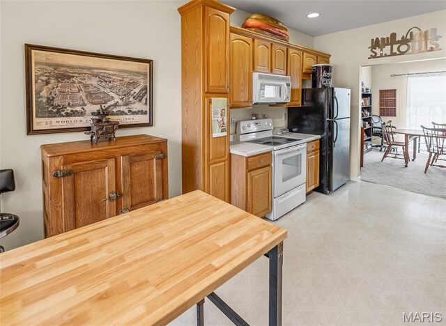 643 Titan Dr, Ofallon, IL 62269 - kitchen featuring white appliances, light flooring, brown cabinets, and recessed lighting