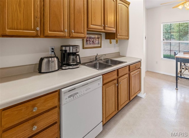 643 Titan Dr, Ofallon, IL 62269 - kitchen with white dishwasher, light flooring, light countertops, and brown cabinetry