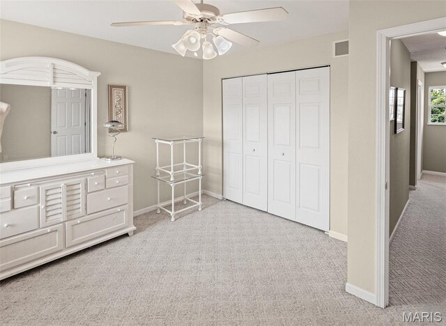 643 Titan Dr, Ofallon, IL 62269 - bedroom with light colored carpet, a closet, and ceiling fan