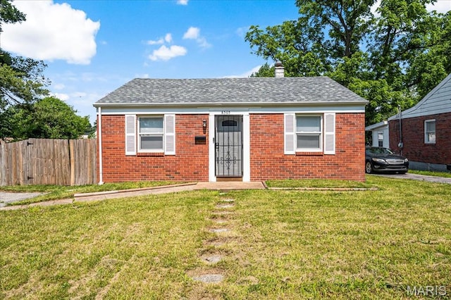 8505 Church Bell Ln, Jennings, MO 63136 - bungalow-style house with a chimney, brick siding, and a shingled roof