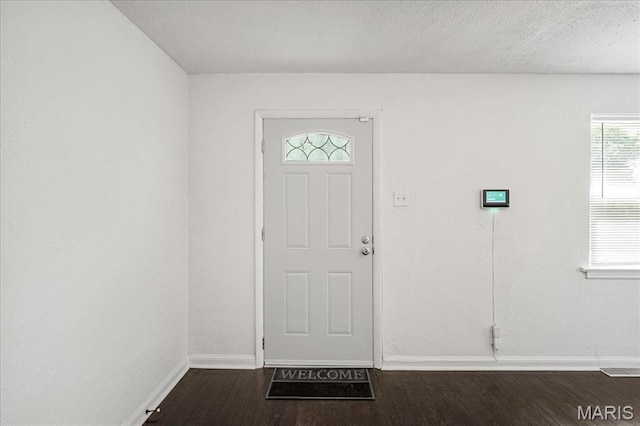 8505 Church Bell Ln, Jennings, MO 63136 - foyer entrance with dark wood finished floors and a textured ceiling