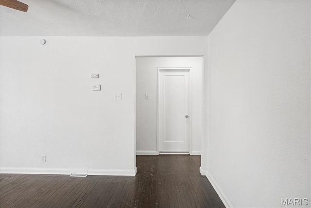 8505 Church Bell Ln, Jennings, MO 63136 - empty room featuring dark wood-style floors, ceiling fan, and a textured ceiling
