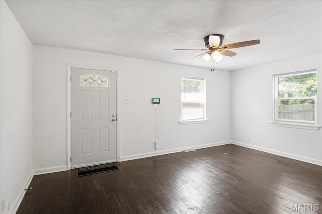 8505 Church Bell Ln, Jennings, MO 63136 - foyer with a ceiling fan, dark wood finished floors, and a textured ceiling