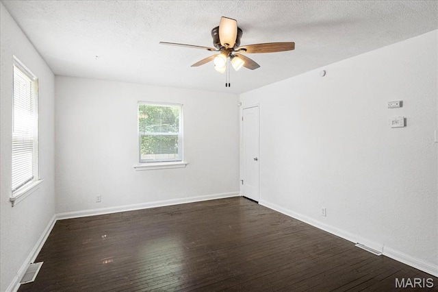 8505 Church Bell Ln, Jennings, MO 63136 - spare room with dark wood-style flooring, ceiling fan, and a textured ceiling